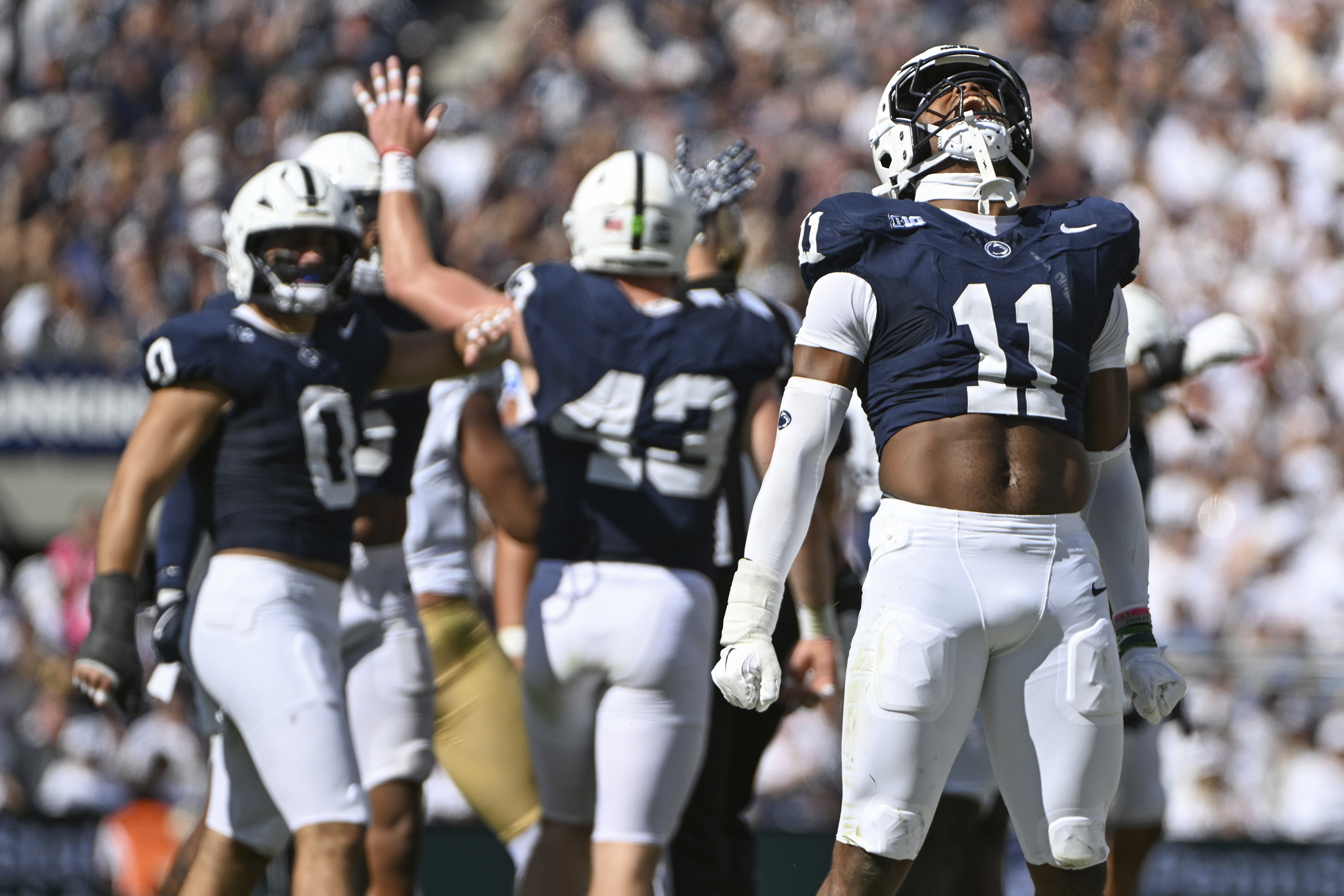 Penn State defensive end Abdul Carter (11) celebrates a tackle against UCLA during the third quarter of an NCAA college football game, Saturday, Oct. 5, 2024, in State College, Pa. 