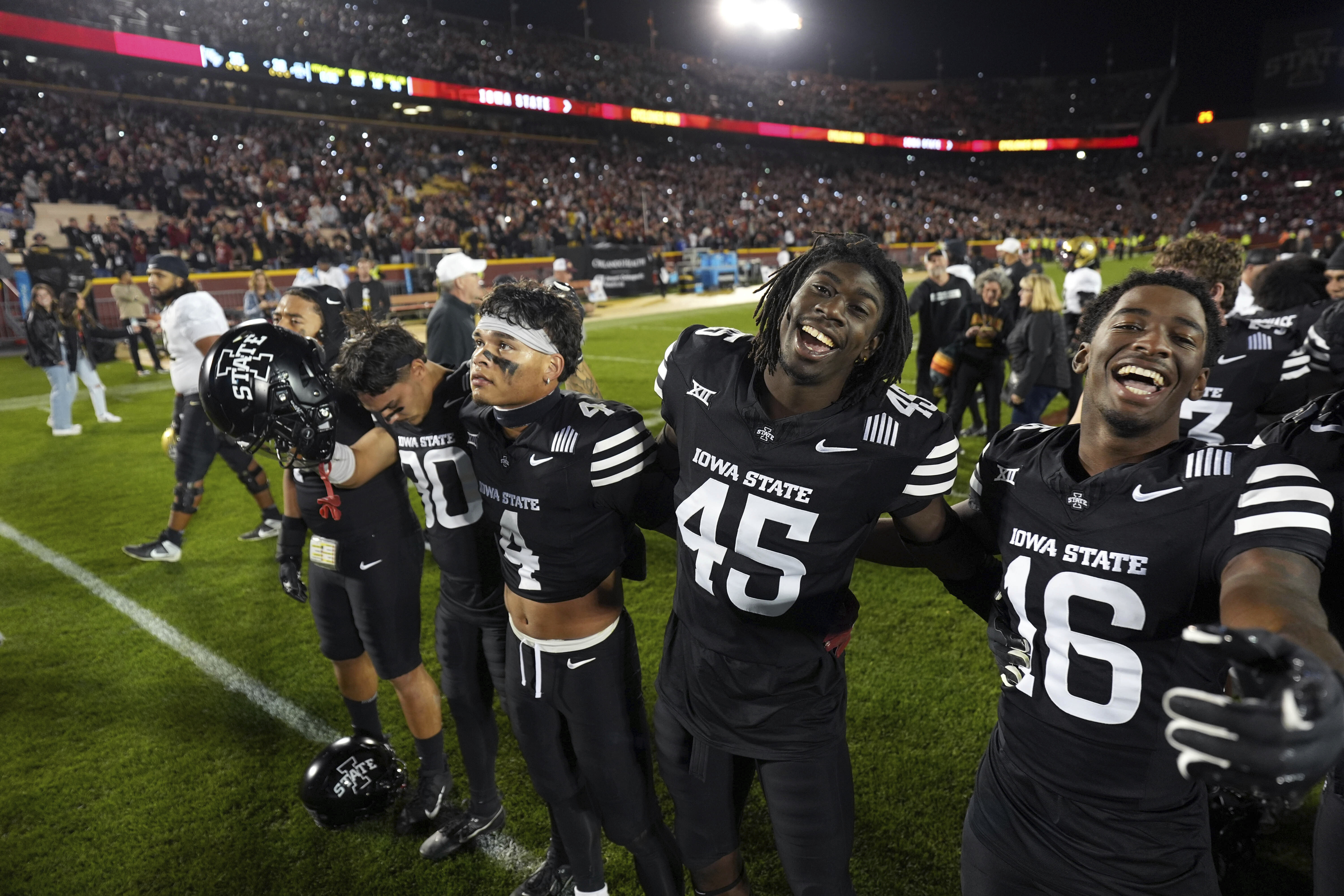 Iowa State's Jonathan Vande Walle (80), Jeremiah Cooper (4), Samuel Same (45), and Matthew Bess celebrate Iowa State's 38-35 victory over Central Florida during an NCAA college football game, Saturday, Oct. 19, 2024, in Ames, Iowa. AP Photo/Matthew Putney)