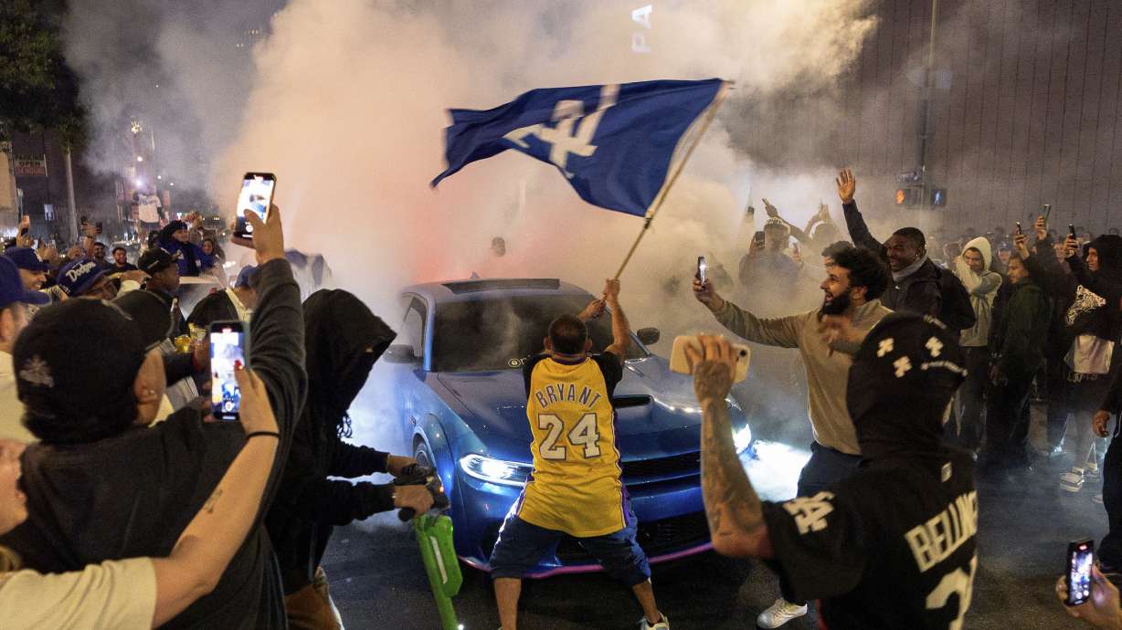 Fans celebrate on the streets after the Los Angeles Dodgers won against the New York Yankees in the baseball World Series Wednesday, Oct. 30, 2024, in downtown Los Angeles.
