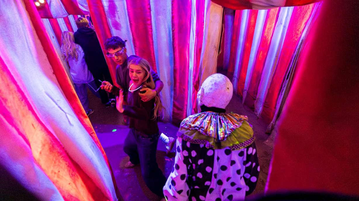 Zoey Nilsson, of Draper, gets a scare from an actor as she and Noah Goeckeritz, of Alpine, walk through Fear Factory in Salt Lake City on Sept. 20.