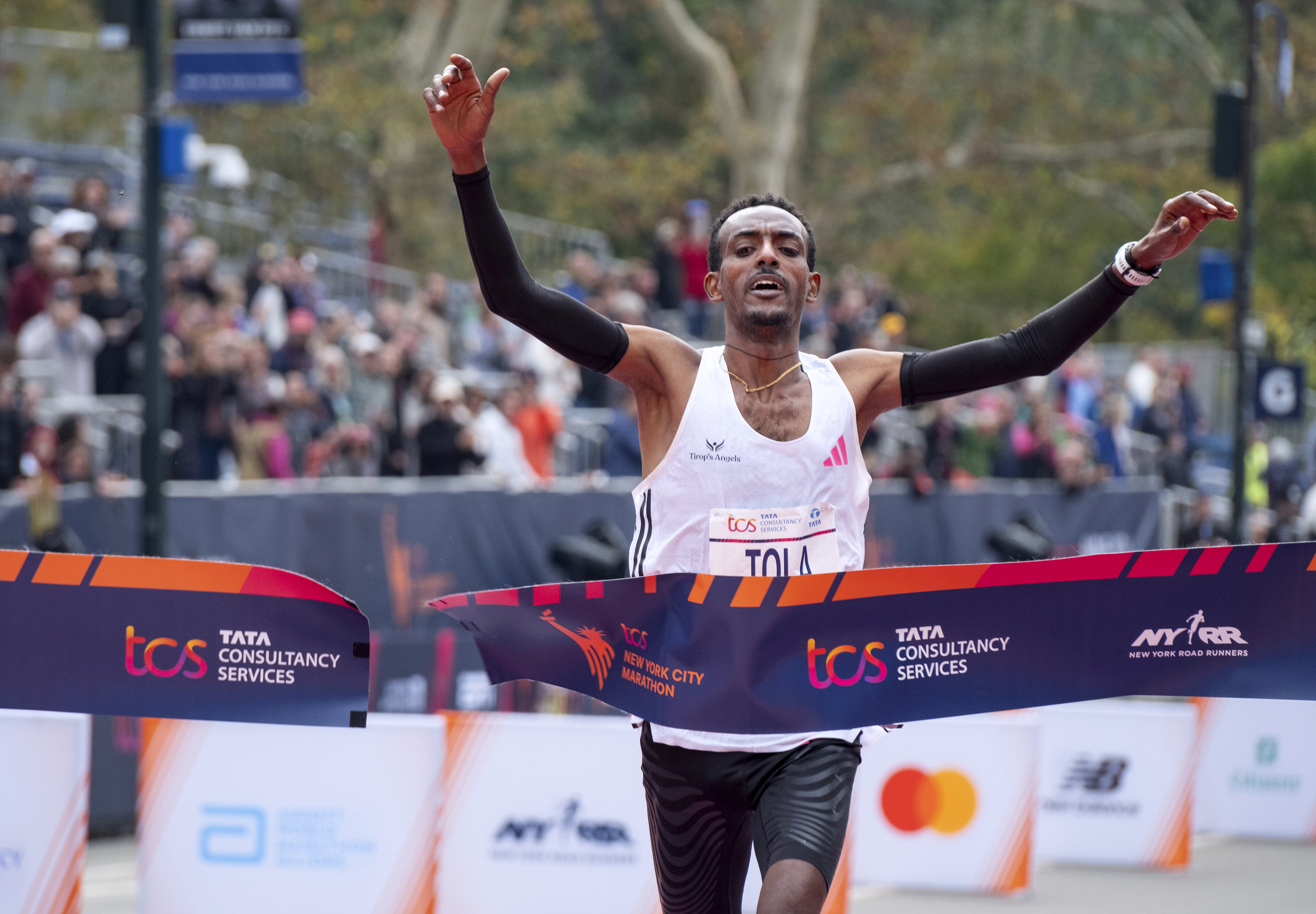 FILE - Tamirat Tola of Ethiopia crosses the finish line to win the men's division of the New York City Marathon, Sunday, Nov. 5, 2023, in New York.