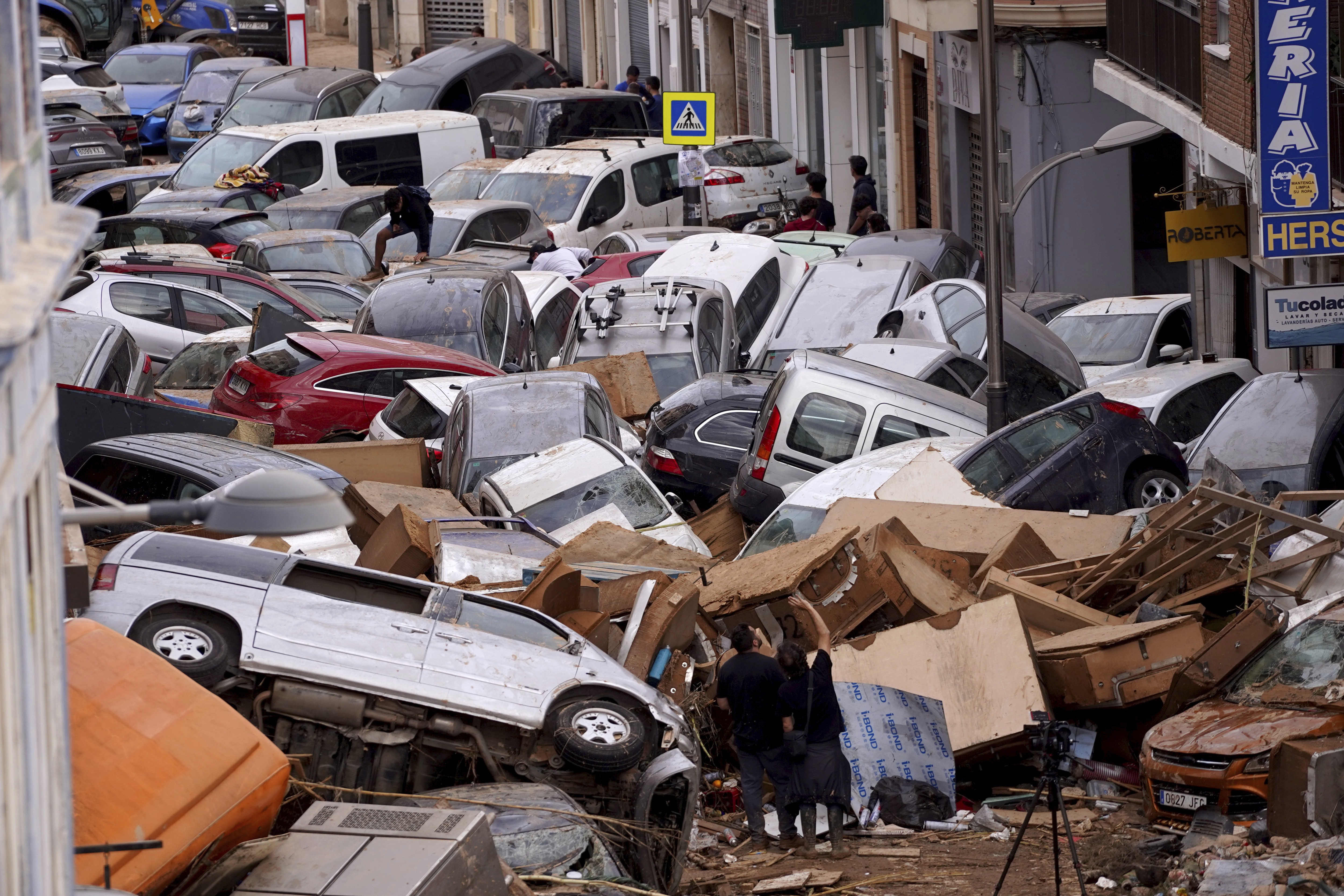 Vehicles are seen piled up after being swept away by floods in Valencia, Spain, Thursday.