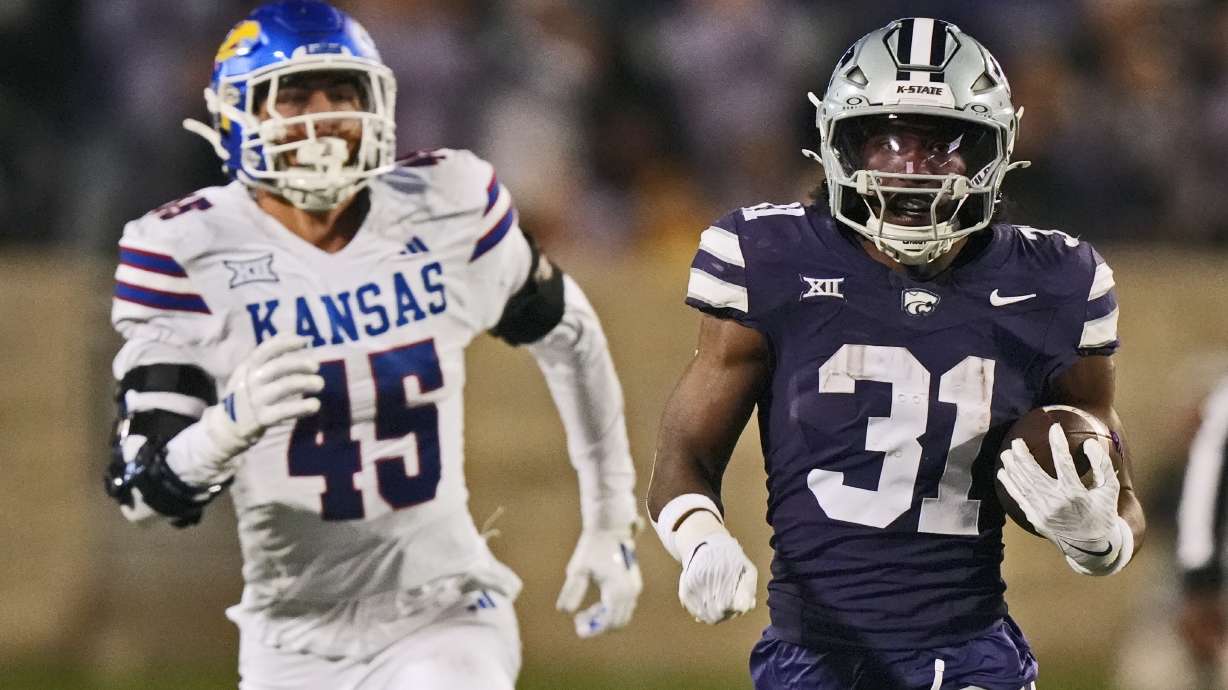 Kansas State running back DJ Giddens (31) is chased by Kansas State linebacker Austin Romaine (45) as he runs for a first dow during the second half of an NCAA college football game Saturday, Oct. 26, 2024, in Manhattan, Kan.