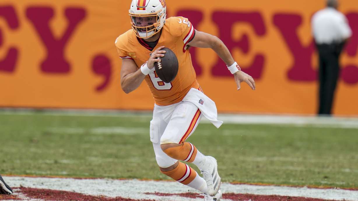 Tampa Bay Buccaneers quarterback Baker Mayfield (6) runs out of the pocket for a first down against the Atlanta Falcons during the second half of an NFL football game, Sunday, Oct. 27, 2024, in Tampa.