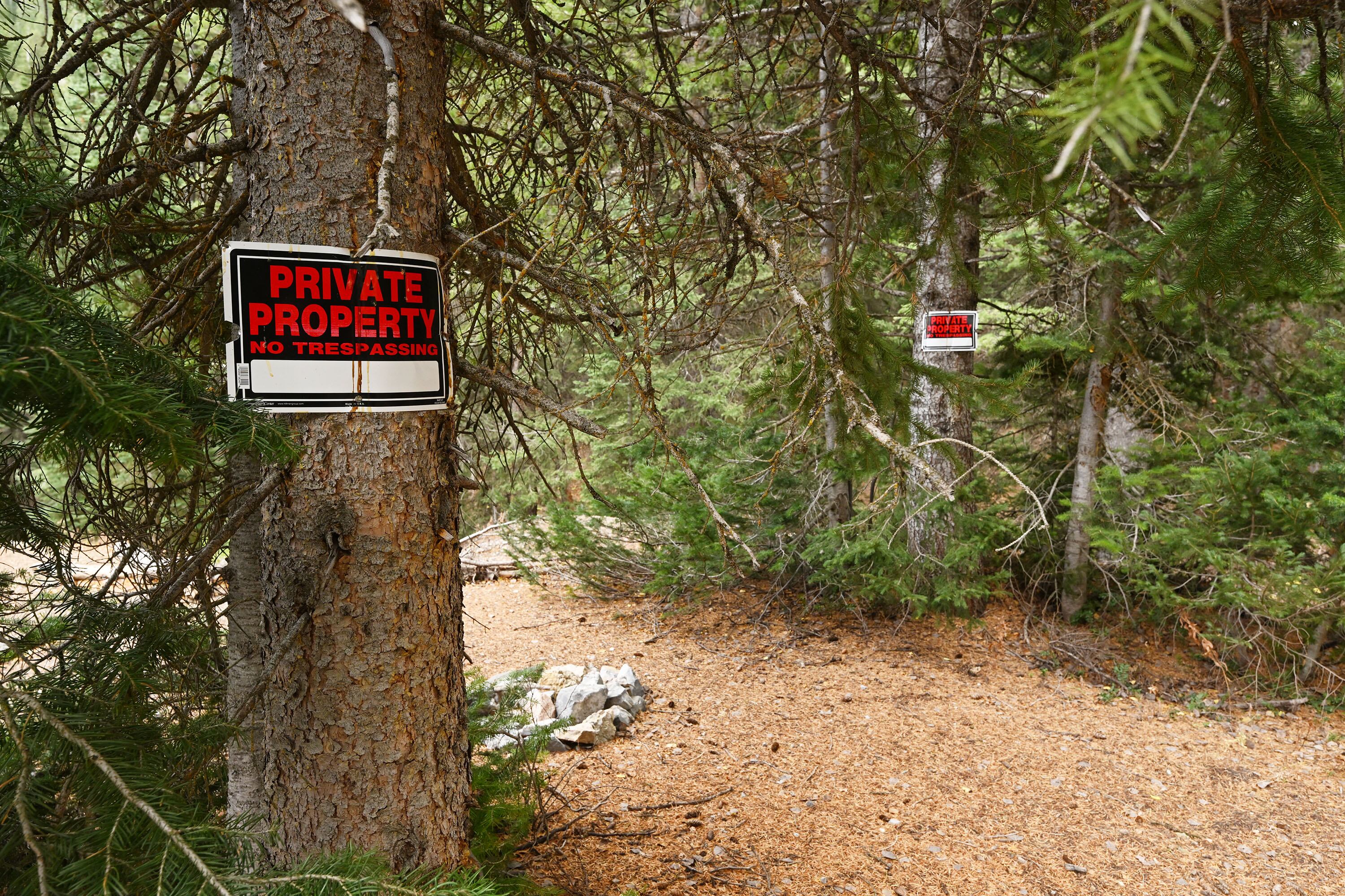 Two of nearly 800 private property/no trespassing signs are seen on trees. A group of concerned landowners, backcountry skiers and hikers are banding together in a coalition to express disappointment in the U.S. Forest Service cutting off access to prime recreational area on private property because it involves a Forest Service road. The group gathered at the Doughnut Falls gate in Big Cottonwood Canyon for a discussion on Oct. 28.