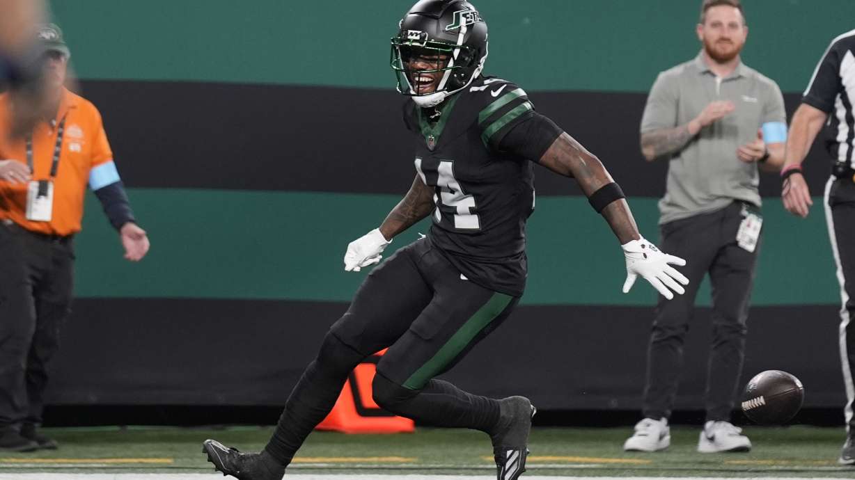 New York Jets wide receiver Malachi Corley drops the football before scoring a touchdown during the first half an NFL football game against the Houston Texans, Thursday, Oct. 31, 2024, in East Rutherford, N.J.