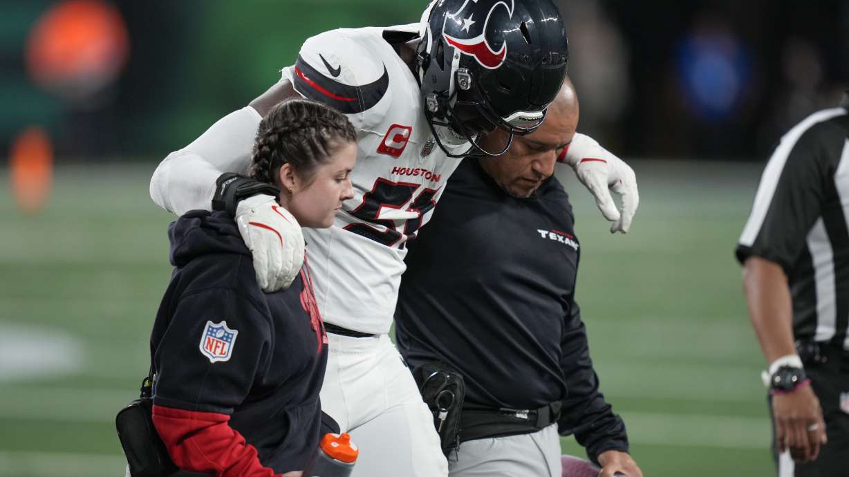 Houston Texans defensive end Will Anderson Jr. (51) is helped off the field after an injury during the first half an NFL football game against the New York Jets, Thursday, Oct. 31, 2024, in East Rutherford, N.J.