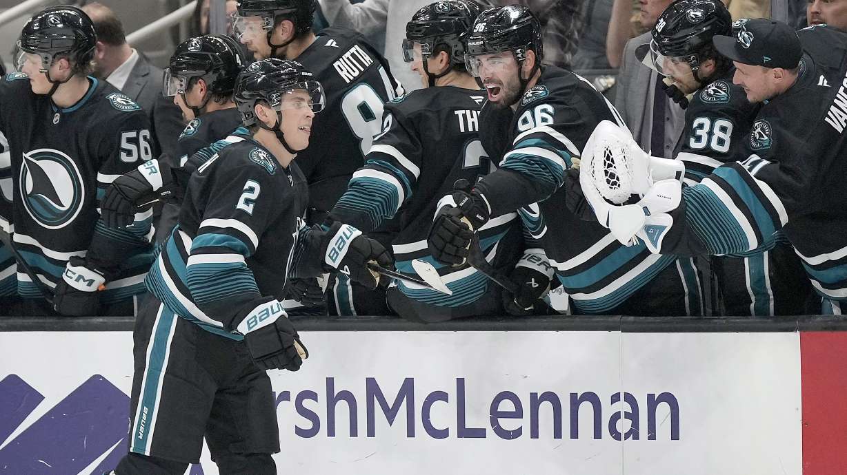 San Jose Sharks center Will Smith (2) celebrates with teammates after scoring a goal against the Chicago Blackhawks during the second period of an NHL hockey game in San Jose, Calif., Thursday, Oct. 31, 2024.