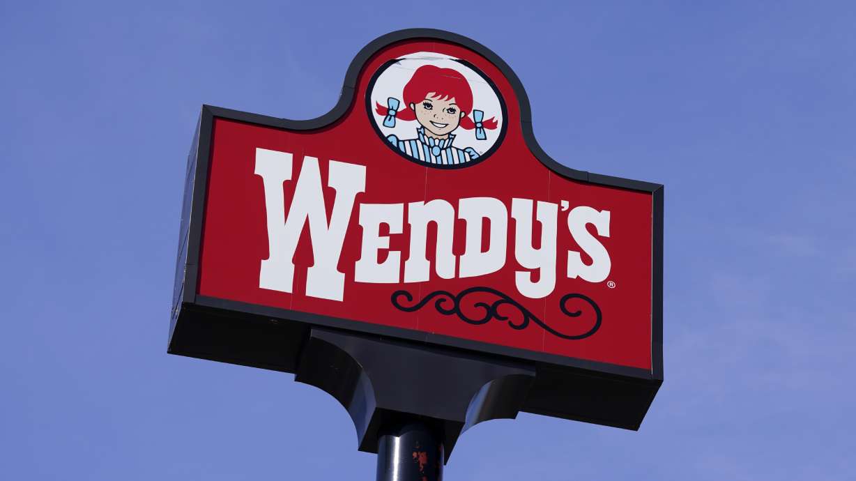A sign for Wendy's restaurant stands over one of its locations, Feb. 25, 2021, in Des Moines, Iowa. Wendy's plans to close 140 U.S. restaurants before the end of this year on top of the 100 it said it would close in May.