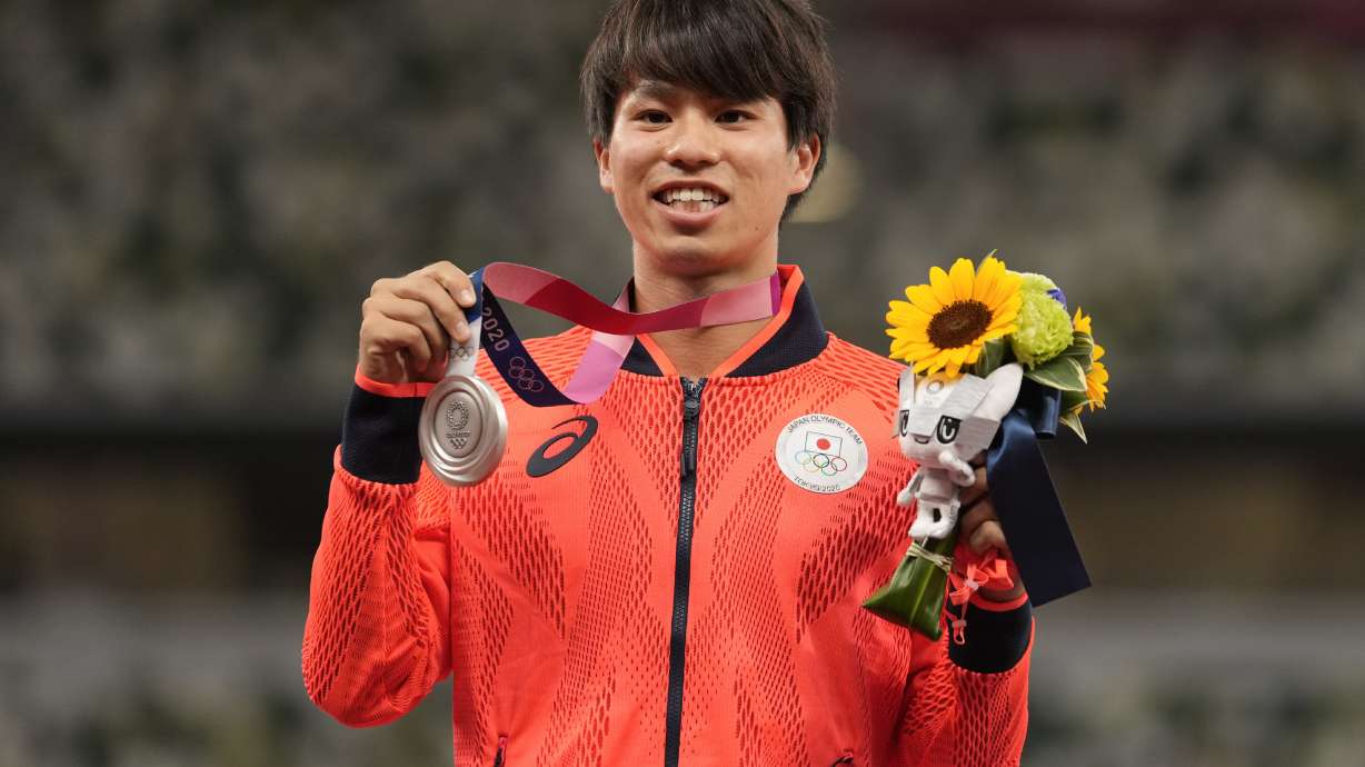 FILE - Silver medalist Koki Ikeda, of Japan, poses during the medal ceremony for the men's 20km race walk at the 2020 Summer Olympics, Aug. 6, 2021, in Tokyo.