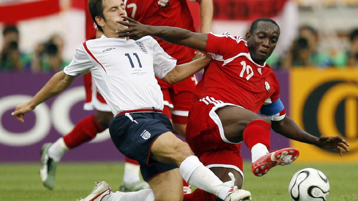 FILE - England's Joe Cole, left and Trinidad & Tobago's Dwight Yorke fight for the ball during the first half of their World Cup Group B soccer match in Nuremberg, Germany, June 15, 2006.