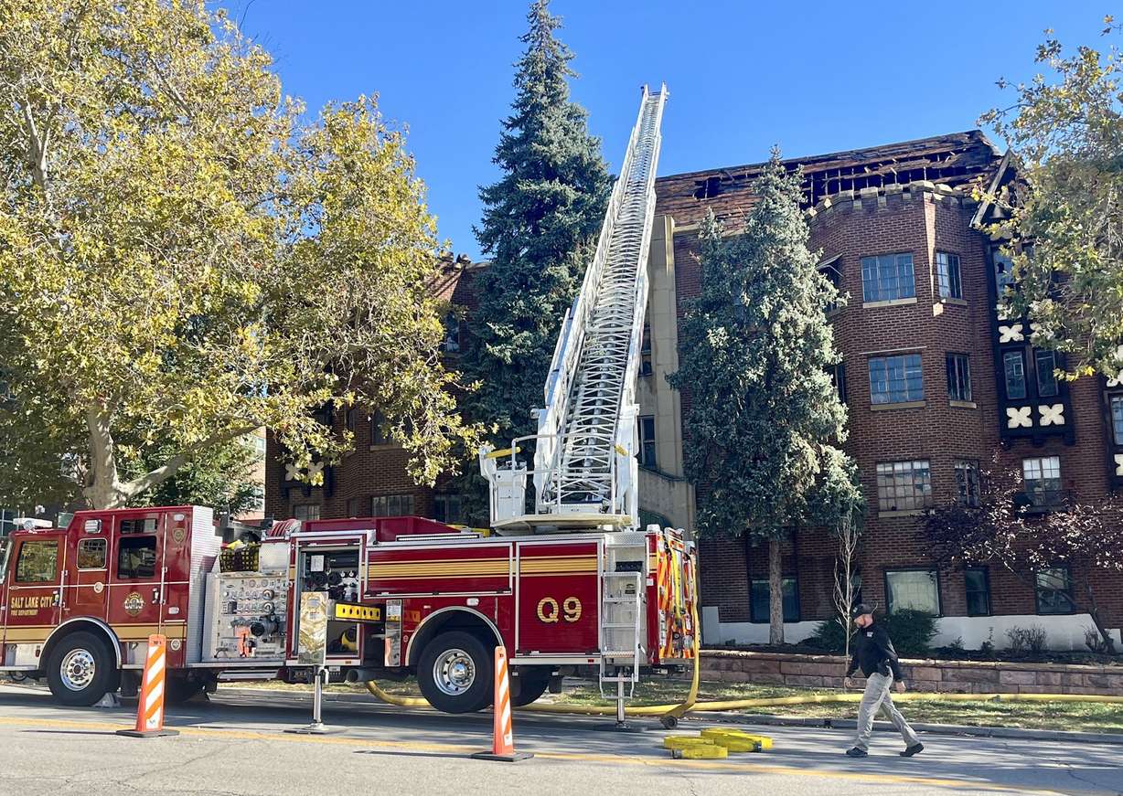 Salt Lake City firefighters remain at the abandoned Chateau Normandie on Friday, inspecting the building after a second fire caused more damage to the building. Crews battled a fire there on Thursday.