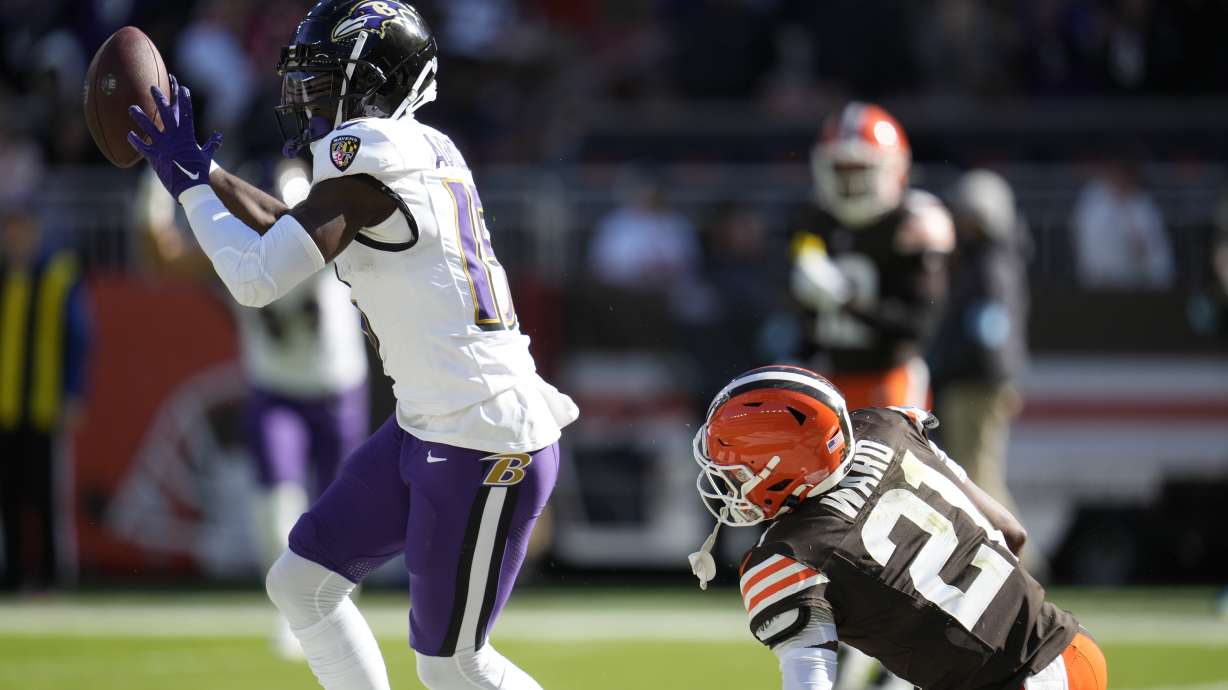 Baltimore Ravens wide receiver Nelson Agholor (15) celebrates a touchdown in front of Cleveland Browns cornerback Denzel Ward (21) during the first half of an NFL football game in Cleveland, Sunday, Oct. 27, 2024.