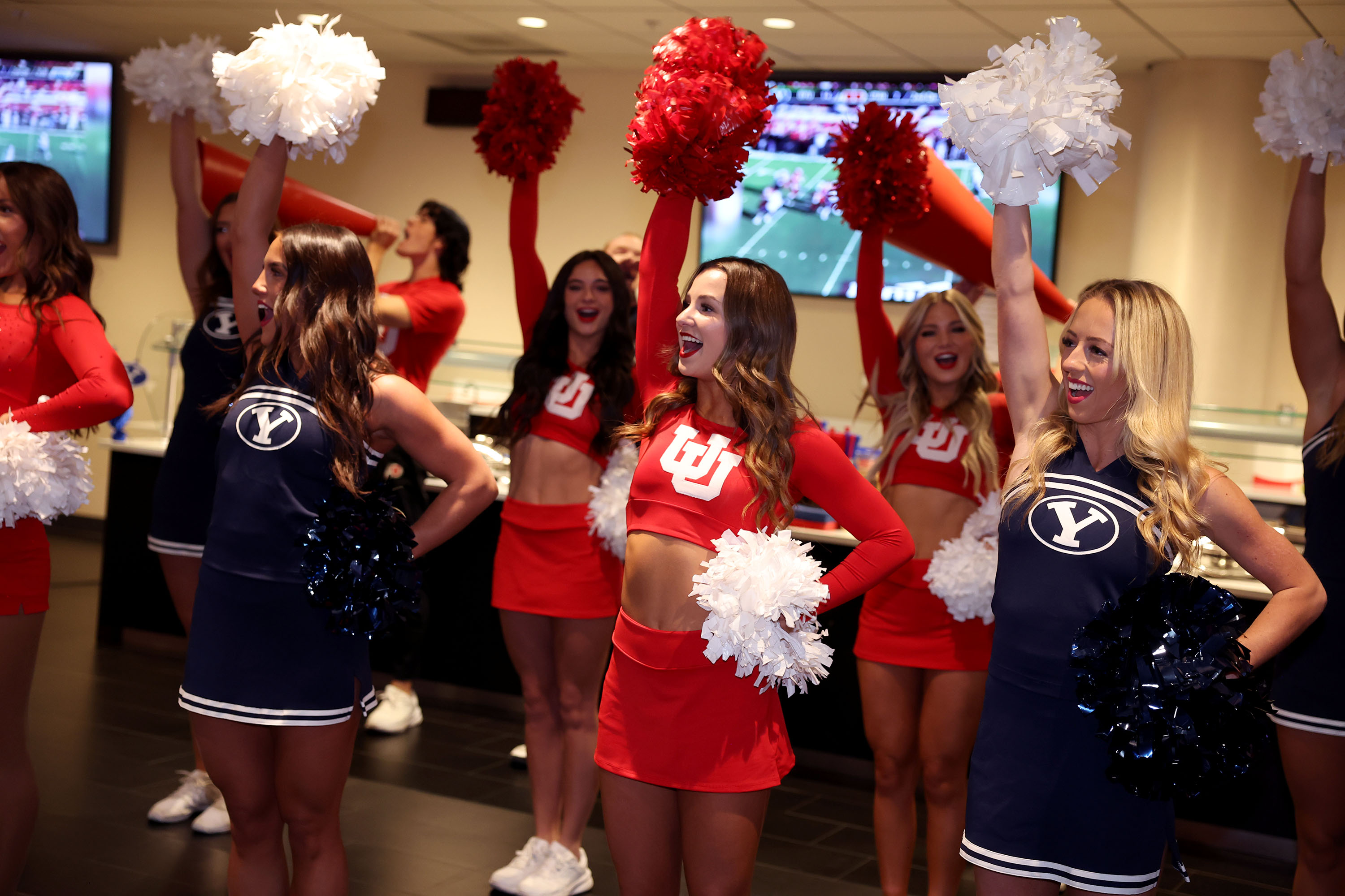 University of Utah and BYU cheerleaders cheer during a news conference to announce a joint service initiative with BYU and the University of Utah before their Nov. 9 game at the Delta Center in Salt Lake City on Friday.