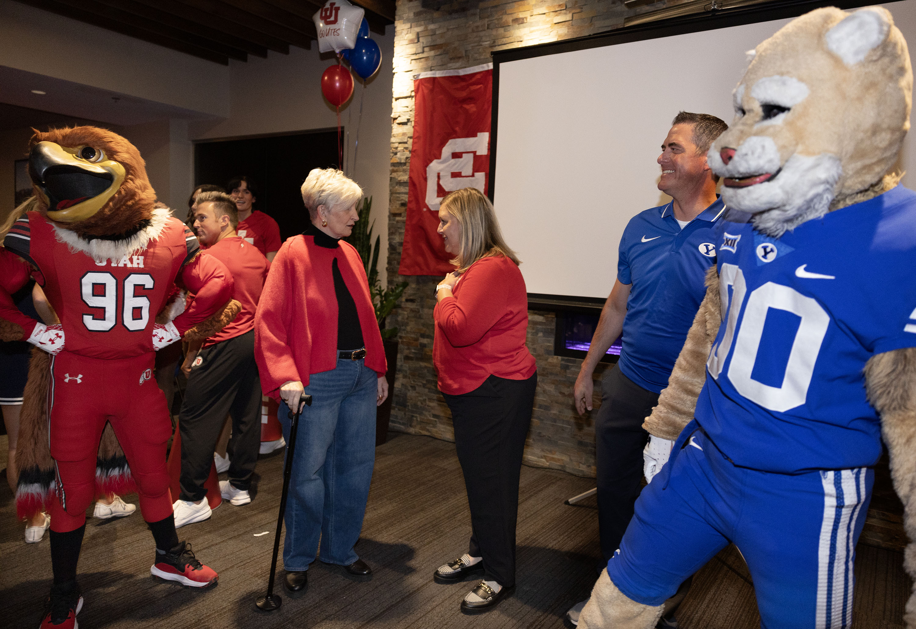 Ginette Bott, president and CEO of the Utah Food Bank; Kris Bosman, Chief Alumni Relations Officer, University of Utah; and Michael Johanson, executive director of the BYU Alumni Association, speak at a news conference to announce a joint service initiative with the University of Utah and BYU at the Delta Center in Salt Lake City on Friday.