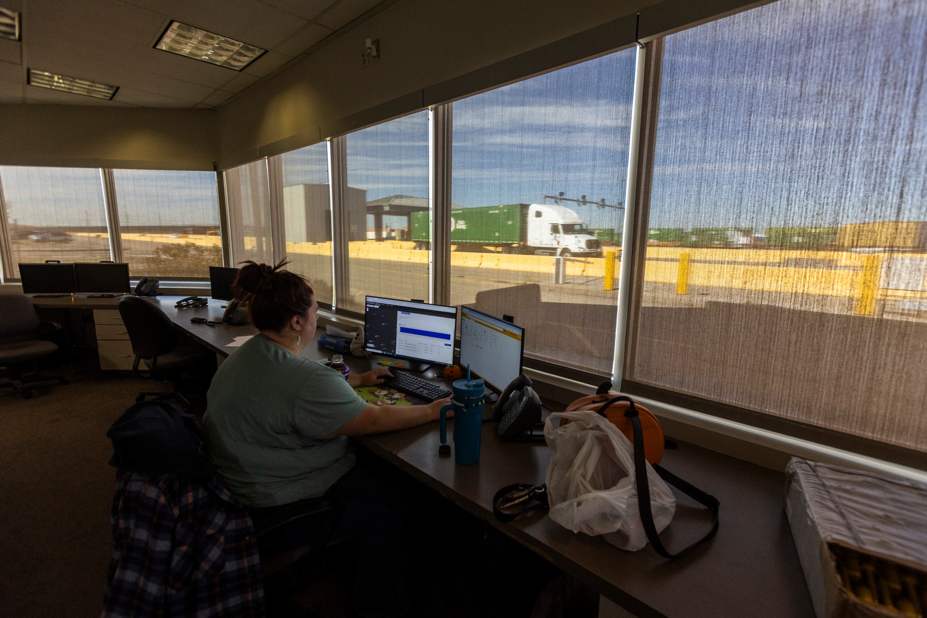 Yard checker Staci Stratton works on an inventory of the yard while semitrailers drive through the Salt Lake City Intermodal Terminal in Salt Lake City on Friday. Utah has been selected by the U.S. Environmental Protection Agency to receive a historic grant of $112 million through the Clean Ports Program.