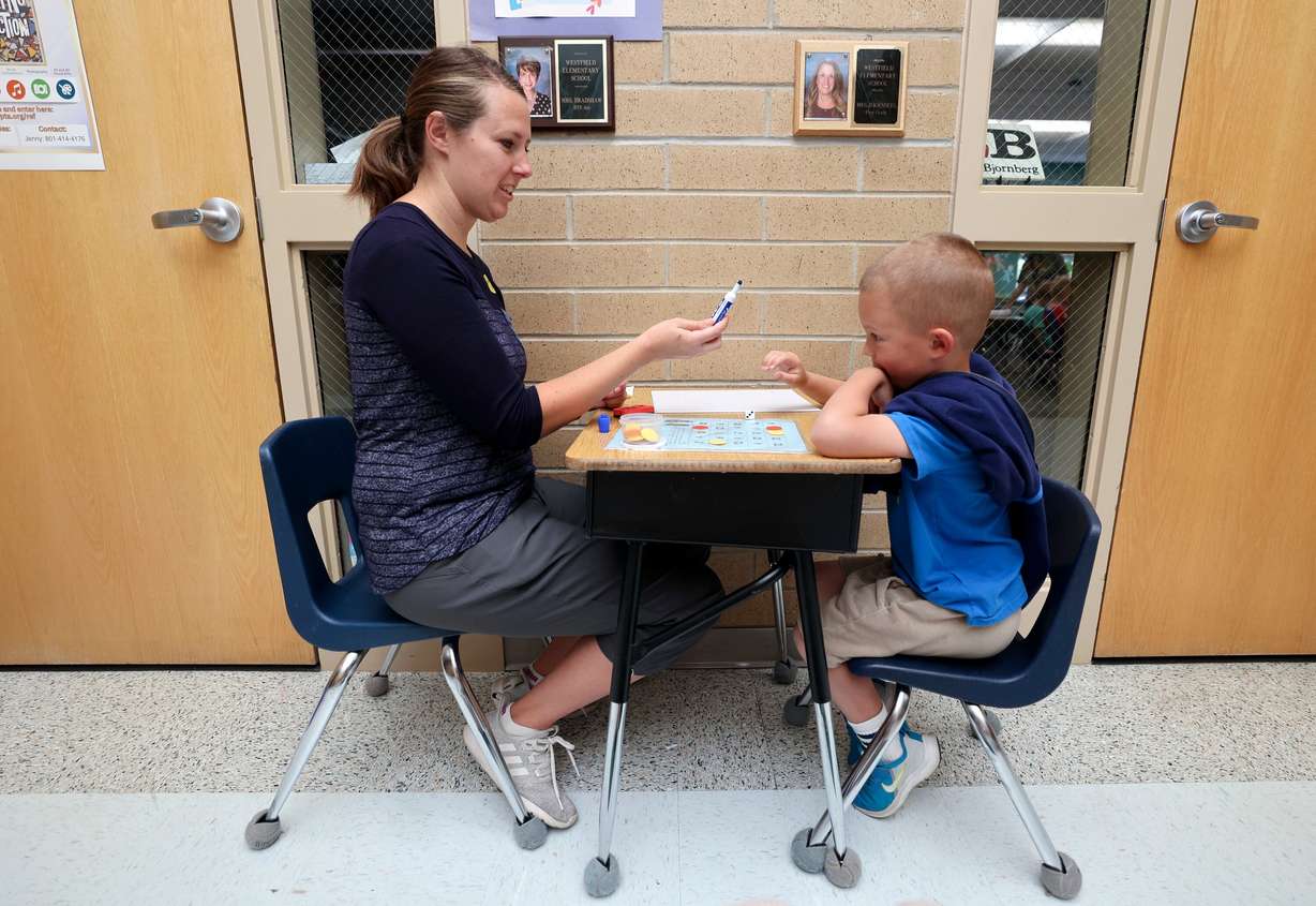 Mary Mahoney, a parent volunteer, helps Max Nelson with math at Westfield Elementary School in Alpine on Oct. 16.
