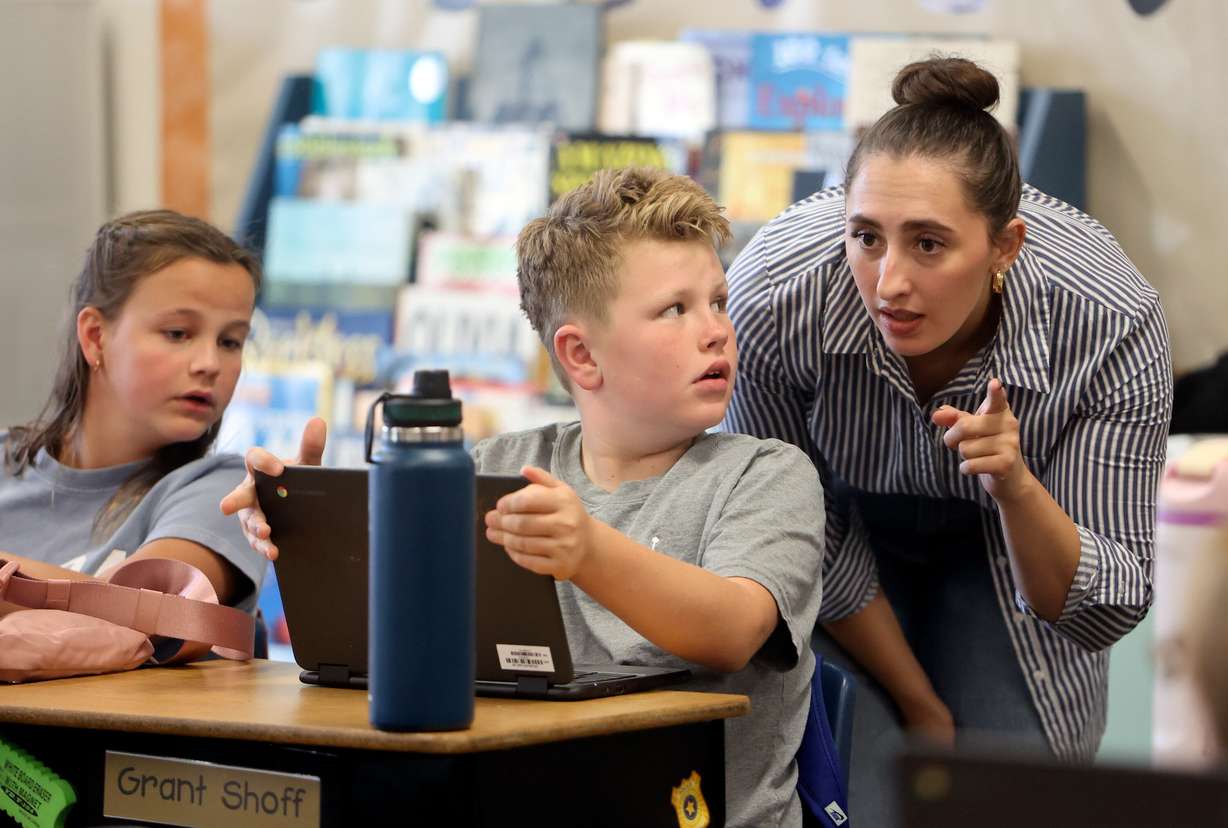 Madelynne Evans, a parent volunteer, helps Grant Shoff in Kristin Kukahiko’s fifth grade class at Westfield Elementary School in Alpine on Oct. 16.