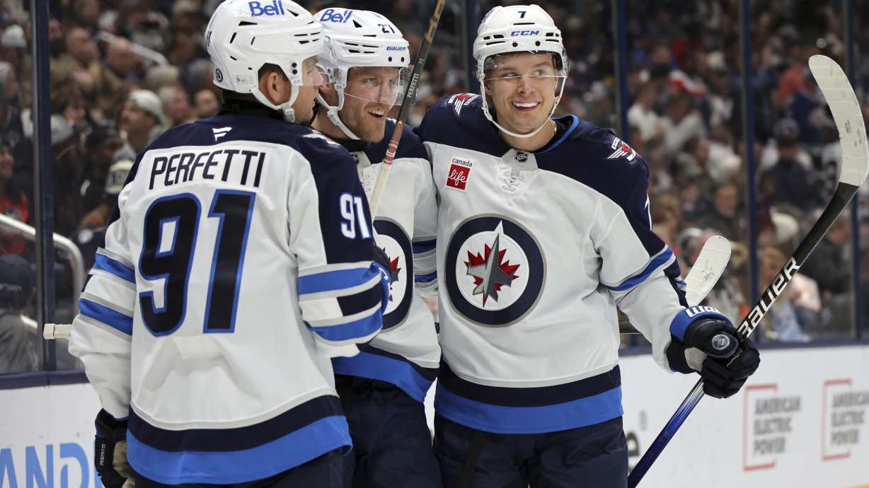 Winnipeg Jets forward Nikolaj Ehlers, center, celebrates his second goal against the Columbus Blue Jackets with teammate forward Cole Perfetti, left, and forward Vladislav Namestnikov during the first period of an NHL hockey game in Columbus, Ohio, Friday, Nov. 1, 2024. Ehlers scored three during the game and the Jets won 6-2.