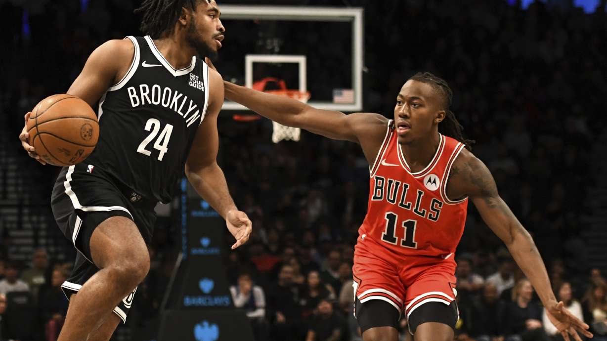 Brooklyn Nets' Cam Thomas, left, dribbles the ball against Chicago Bulls' Ayo Dosunmu, right, during the first half of an NBA basketball game, Friday, Nov. 1, 2024, in New York.