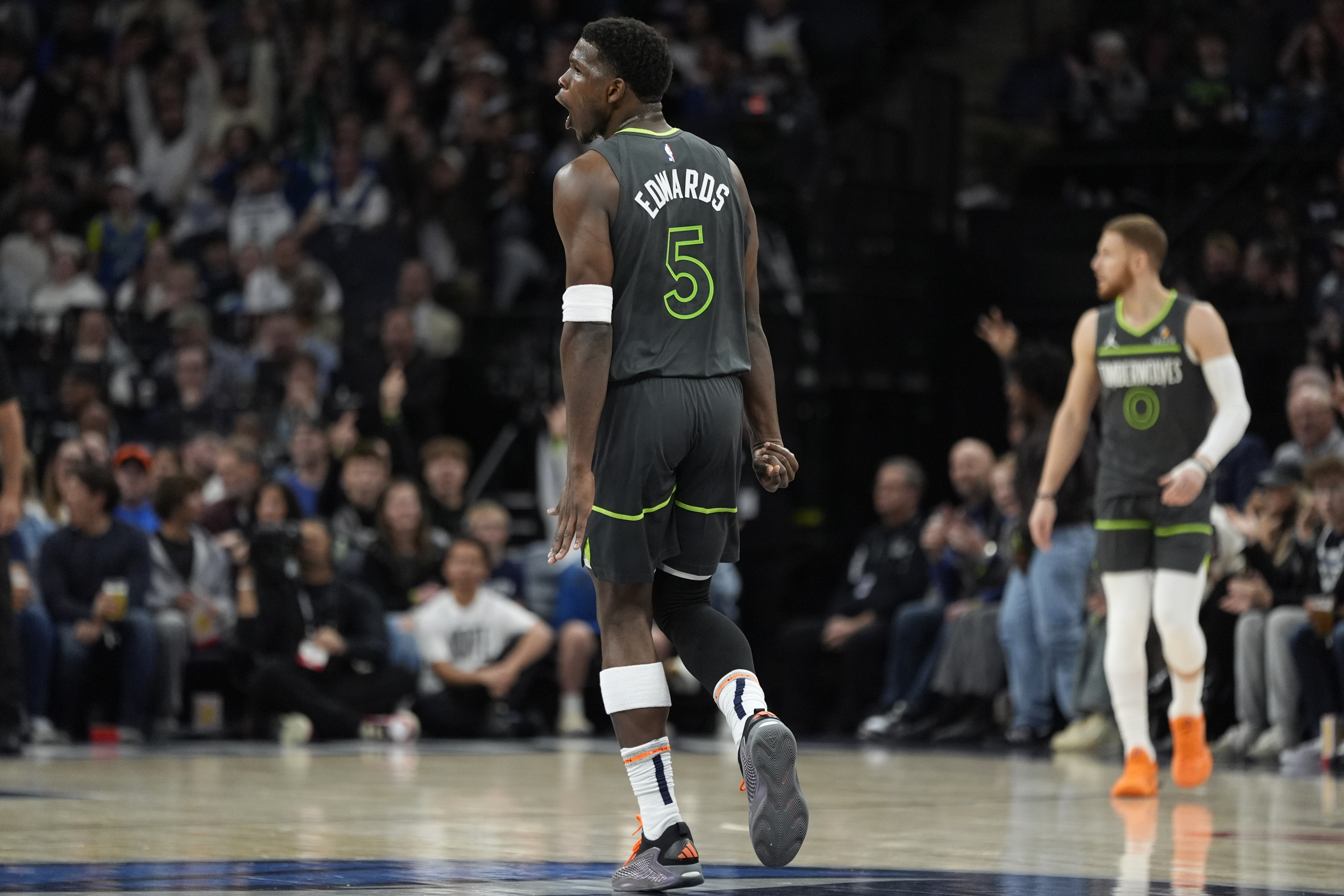Minnesota Timberwolves guard Anthony Edwards (5) reacts after making a 3-point shot during the first half of an NBA basketball game against the Denver Nuggets, Friday, Nov. 1, 2024, in Minneapolis.