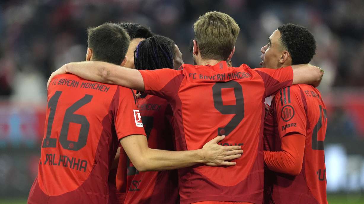 Bayern Munich players celebrate after Bayern's Harry Kane, centre, scored his side's third goal during the Bundesliga soccer match between Bayern Munich and Union Berlin at the Allianz Arena in Munich, Germany, Saturday, Nov. 2, 2024.