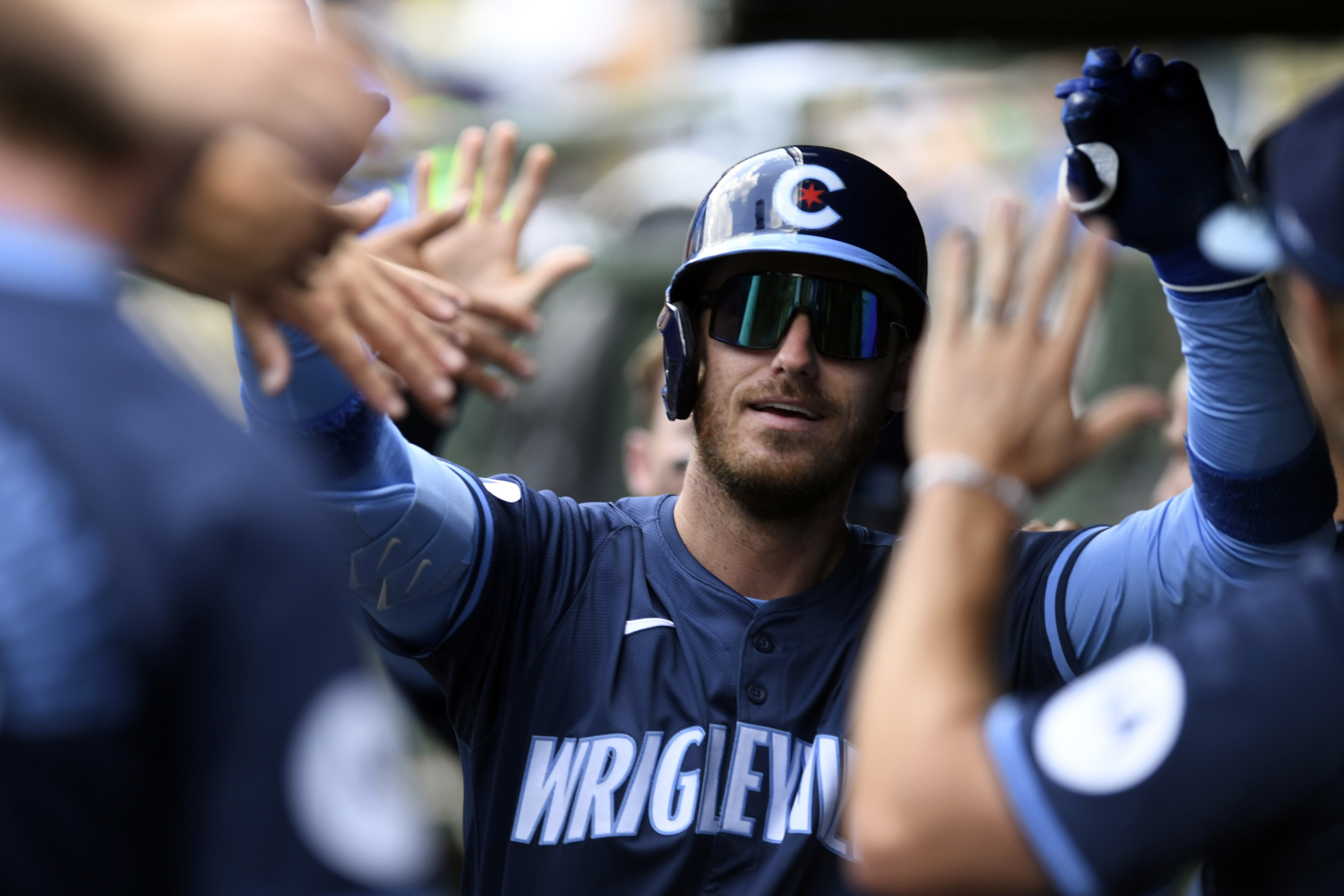 FILE- Chicago Cubs' Cody Bellinger (24) celebrates with teammates in the dugout after hitting a two-run home run during the first inning of a baseball game against the Toronto Blue Jays in Chicago, Friday, Aug. 16, 2024.