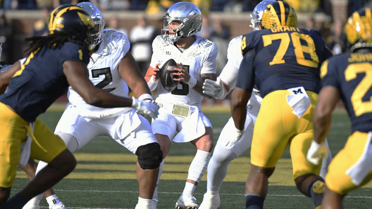 Oregon quarterback Dillon Gabriel (8) looks to pass against Michigan in the first half of an NCAA college football game, Saturday, Nov. 2, 2024, in Ann Arbor, Mich.