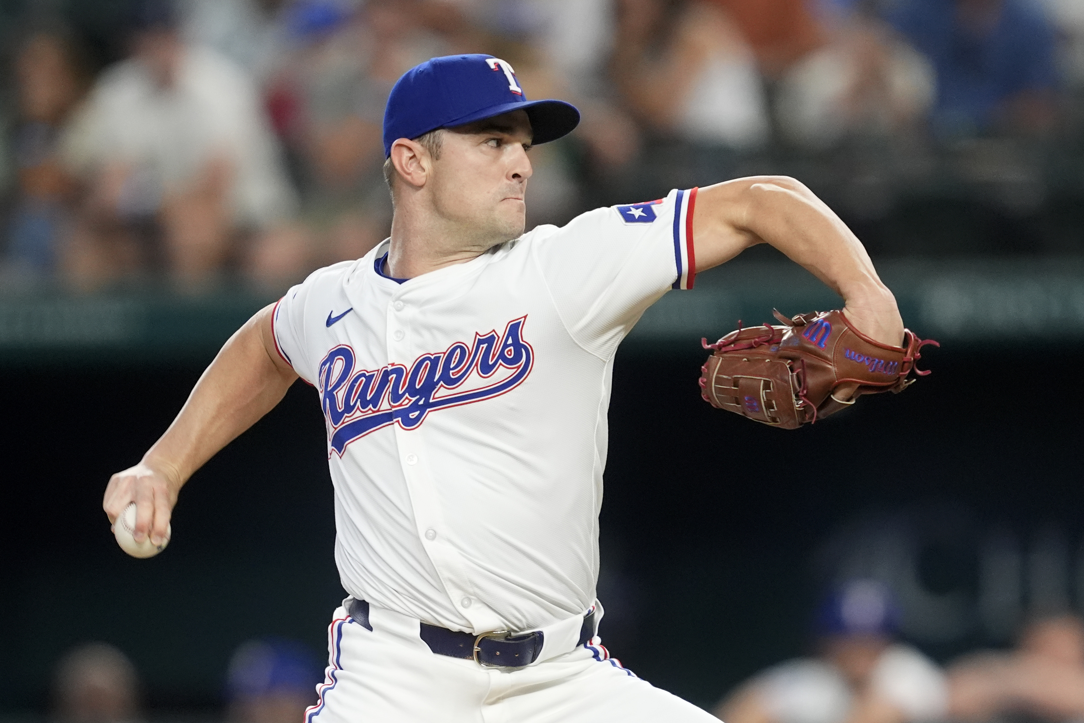 FILE - Texas Rangers relief pitcher David Robertson throws to the Pittsburgh Pirates in the eighth inning of a baseball game, Aug. 21, 2024, in Arlington, Texas.
