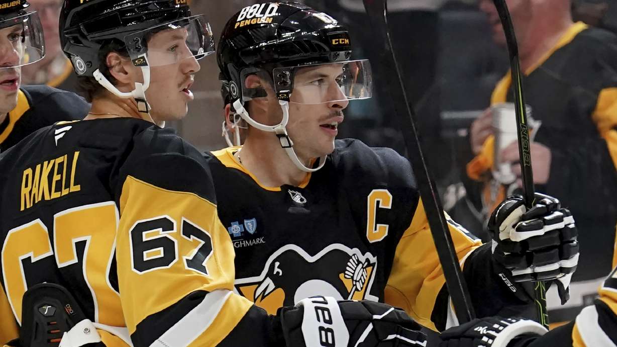 Pittsburgh Penguins' Sidney Crosby, front right, celebrates with teammate Rickard Rakell (67) after scoring during the second period of an NHL hockey game against the Montreal Canadiens, Saturday, Nov. 2, 2024, in Pittsburgh.