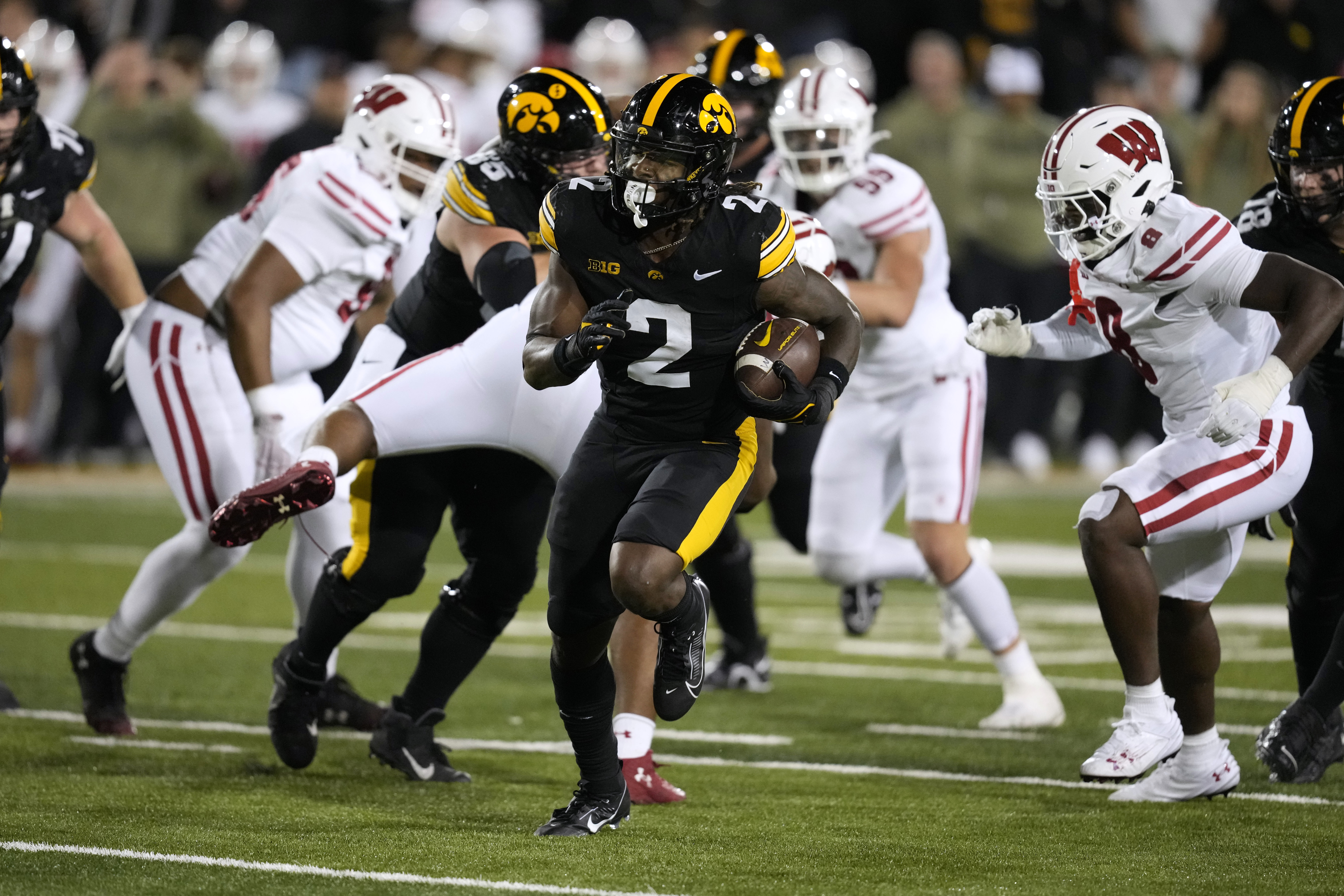 Iowa running back Kaleb Johnson (2) runs from Wisconsin linebacker Leon Lowery Jr., right, during a 16-yard touchdown run in the first half of an NCAA college football game, Saturday, Nov. 2, 2024, in Iowa City, Iowa.