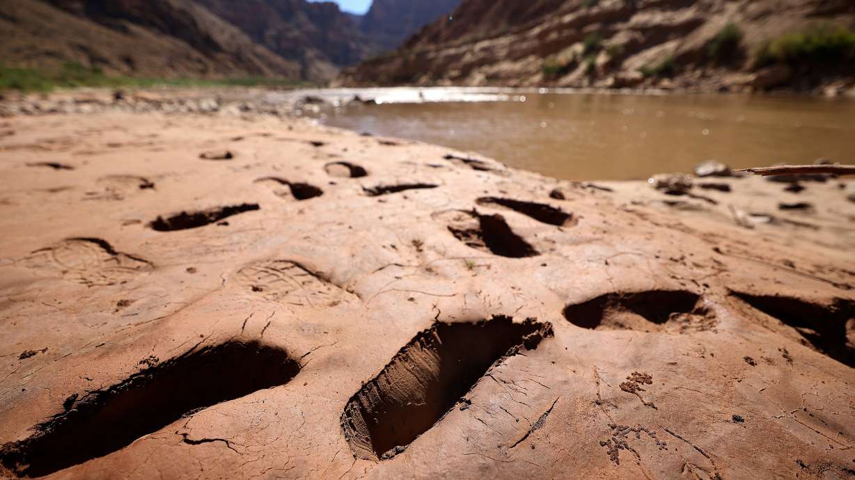 Footprints where people have sunk into mud are pictured above Gypsum Canyon rapid in Cataract Canyon on Sept. 20. The mud is being trapped above Glen Canyon Dam, depriving the river below, and suffocating it above.