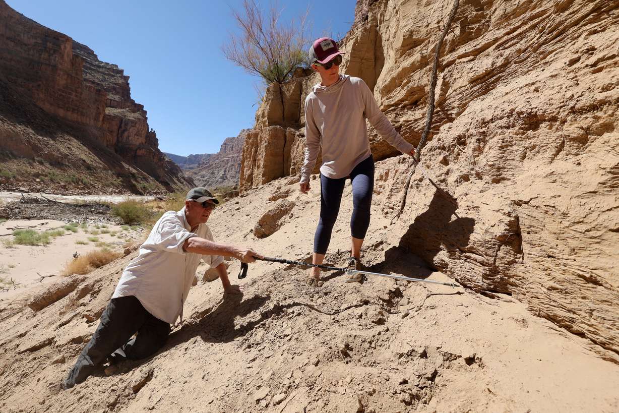 Jack Schmidt, USU’s Janet Quinney Lawson Colorado River Studies chair and Center for Colorado River Studies director, and Meg Flynn, Returning Rapids researcher, climb partially up a 40- to 60-foot high wall of sediment buildup called the Dominy Formation during a Returning Rapids trip in Cataract Canyon on the Colorado River on Sept. 20.
