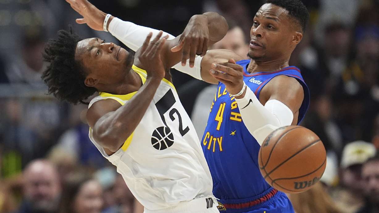 Utah Jazz guard Collin Sexton, left, loses control of the ball as Denver Nuggets guard Russell Westbrook defends in the first half of an NBA basketball game Saturday, Nov. 2, 2024, in Denver.