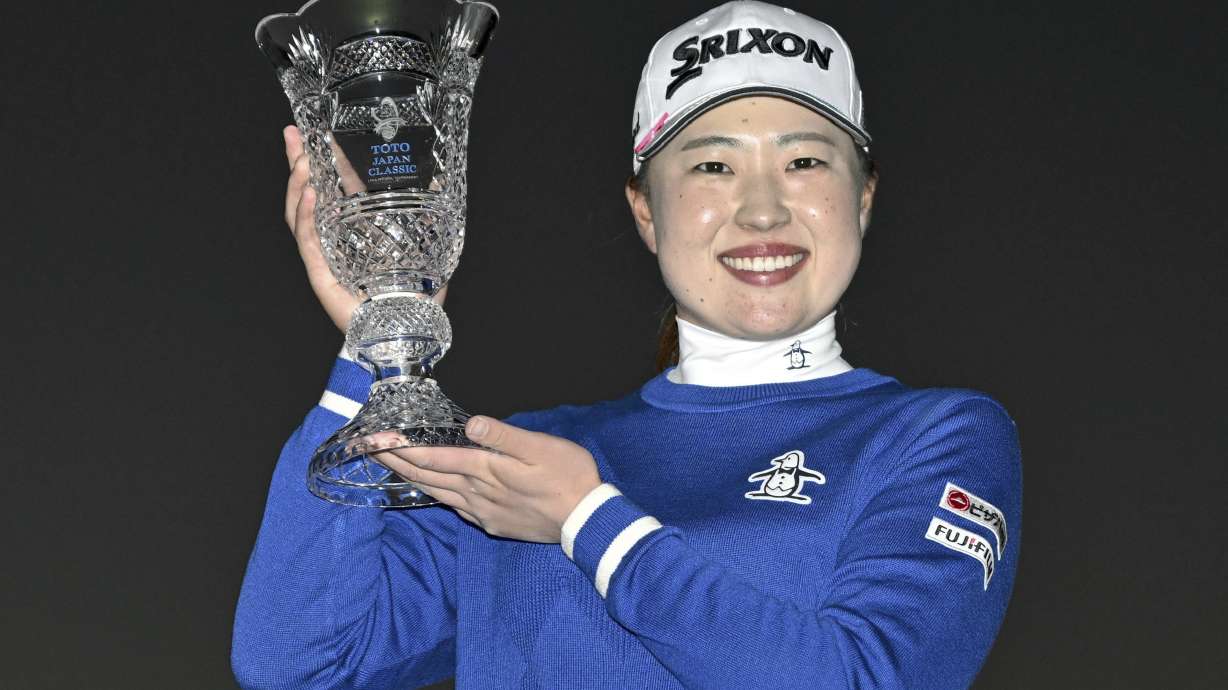 Rio Takeda of Japan holds up her trophy after winning the LPGA's Toto Japan Classic in a playoff at the Seta Golf Course in Otsu, western Japan, Sunday, Nov. 3, 2024.