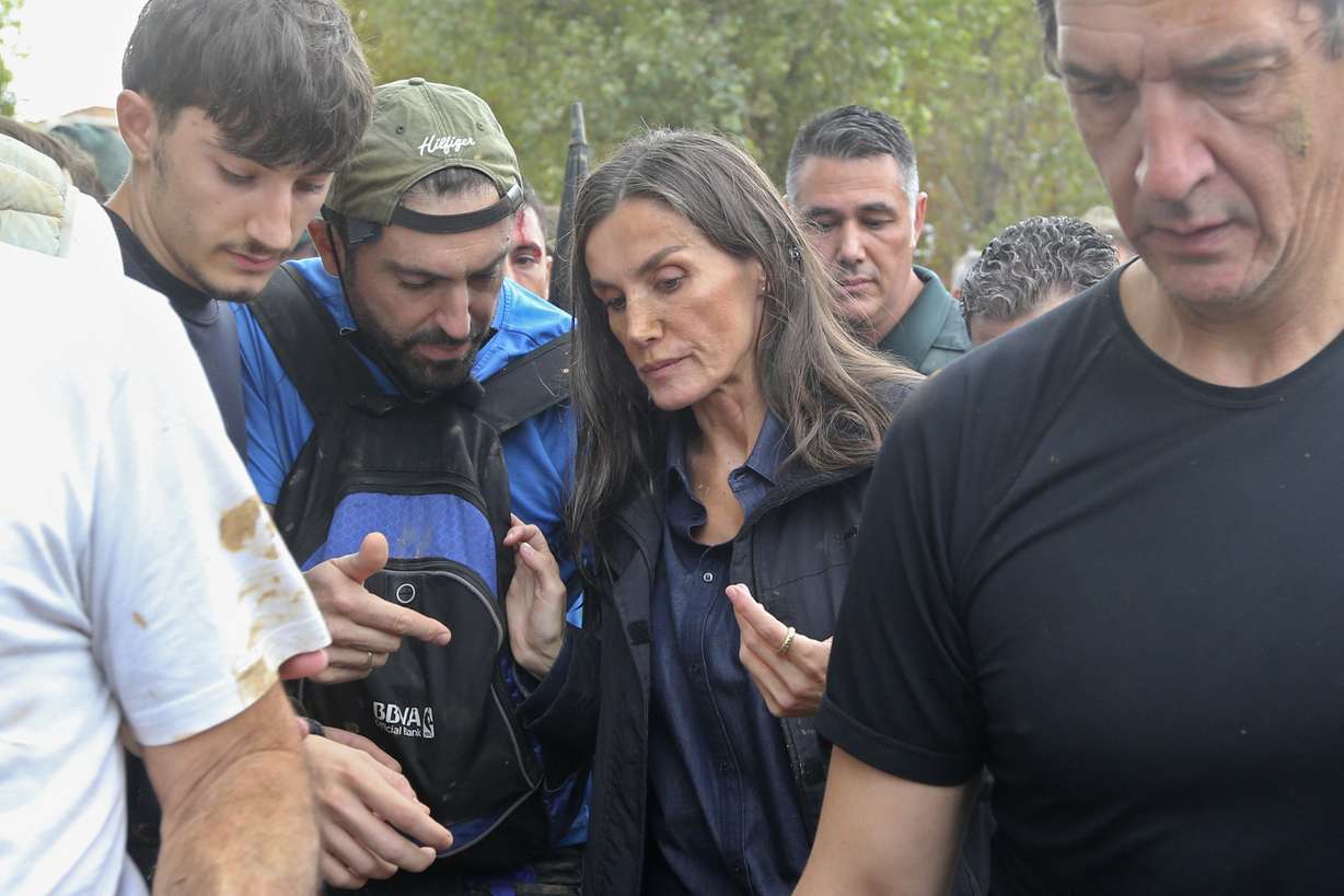 Spain's Queen Letizia speaks with people affected by the floods after crowd of angry survivors of Spain's floods tossed mud and shouted insults at the Spain's King Felipe and government officials near Valencia, Spain, Sunday.