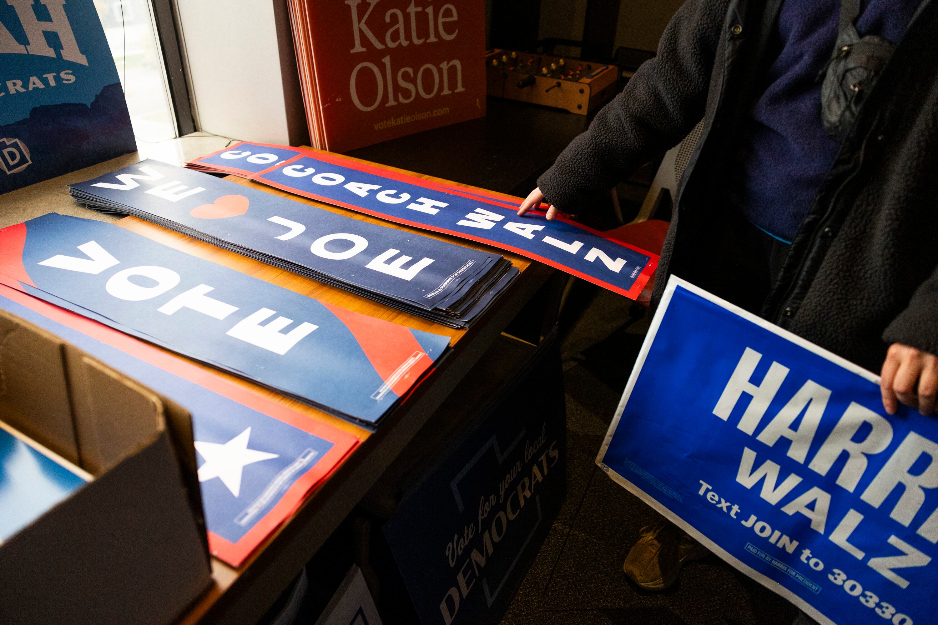 A visitor to the Utah Democratic Party Head Quarters picks out campaign signs to bring home at the Utah Democratic Party Head Quarters in Salt Lake City on Friday.