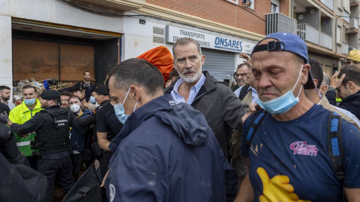 Spain's King Felipe VI, center, walks amidst angry Spanish flood survivors in Paiporta, near Valencia, Spain, Sunday.