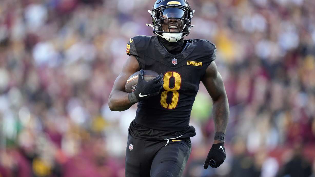 Washington Commanders running back Brian Robinson Jr. (8) carries the ball against the Chicago Bears in the first half of an NFL football game Sunday, Oct. 27, 2024, in Landover, Md.