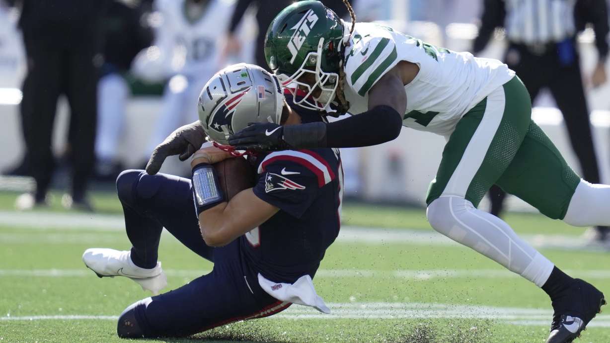 New England Patriots quarterback Drake Maye (10) connects helmet to helmet from behind with New York Jets linebacker Jamien Sherwood (44) in the first half of an NFL football game, Sunday, Oct. 27, 2024, in Foxborough, Mass.
