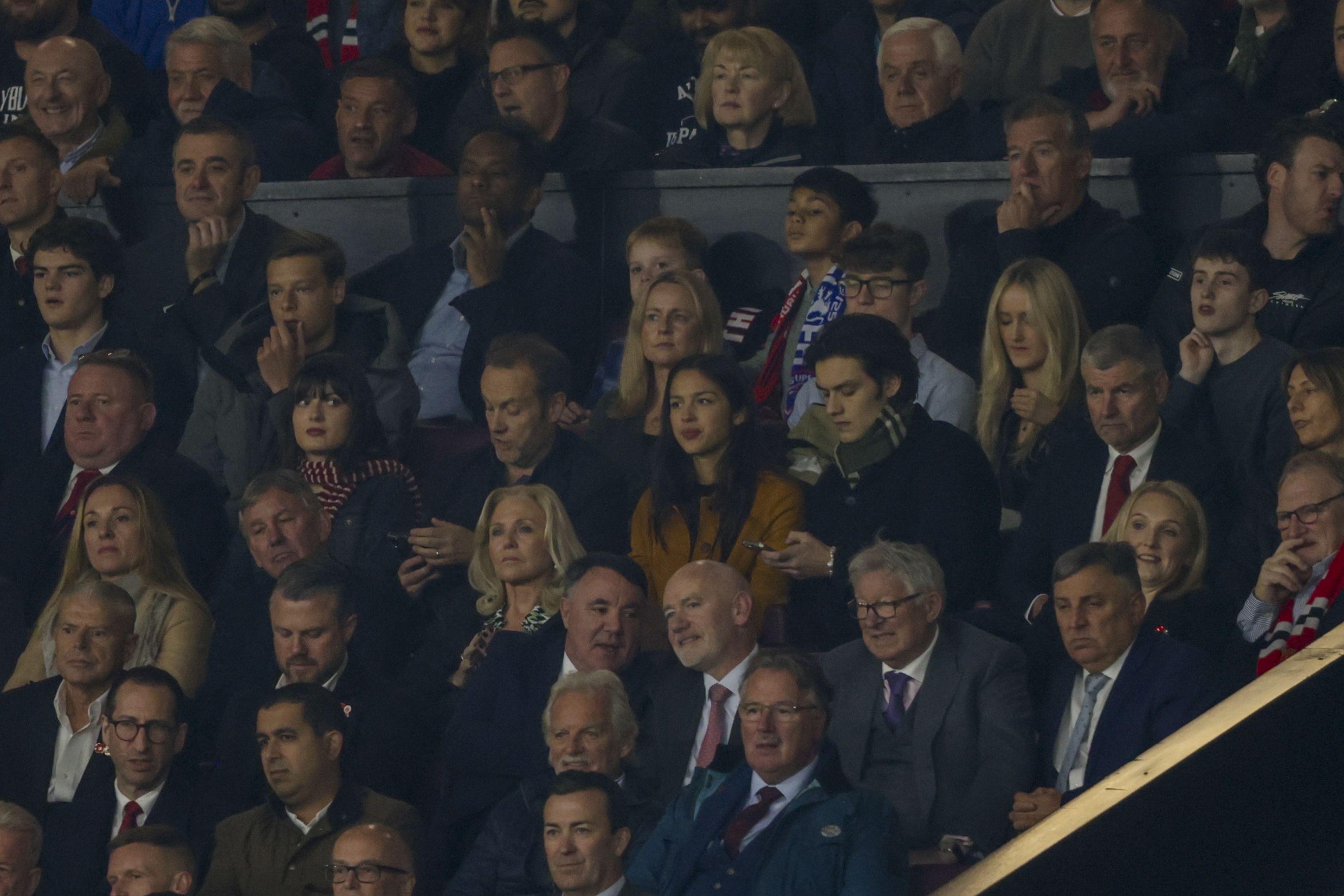 American singer-songwriter and actress Olivia Rodrigo, centre, attends the Premier League soccer match between Manchester United and Chelsea at Old Trafford stadium in Manchester, England, Sunday, Nov. 3, 2024.