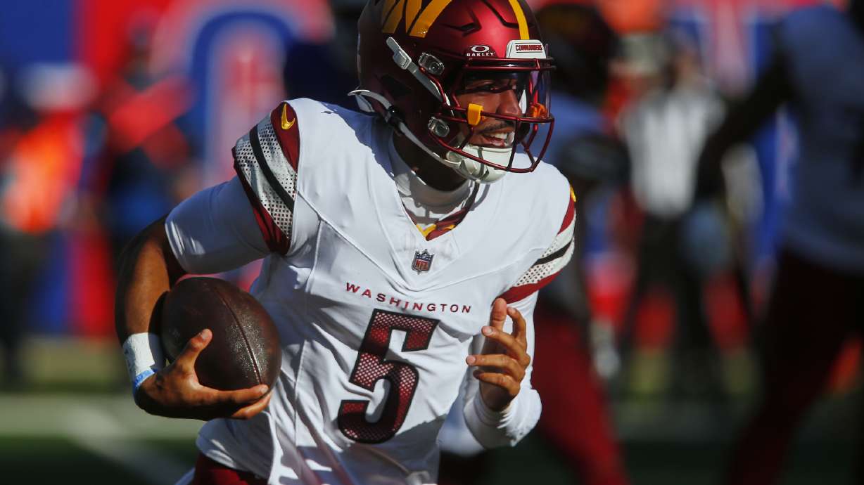 Washington Commanders quarterback Jayden Daniels (5) carries the ball against the New York Giants during the second quarter of an NFL football game, Sunday, Nov. 3, 2024, in East Rutherford, N.J.