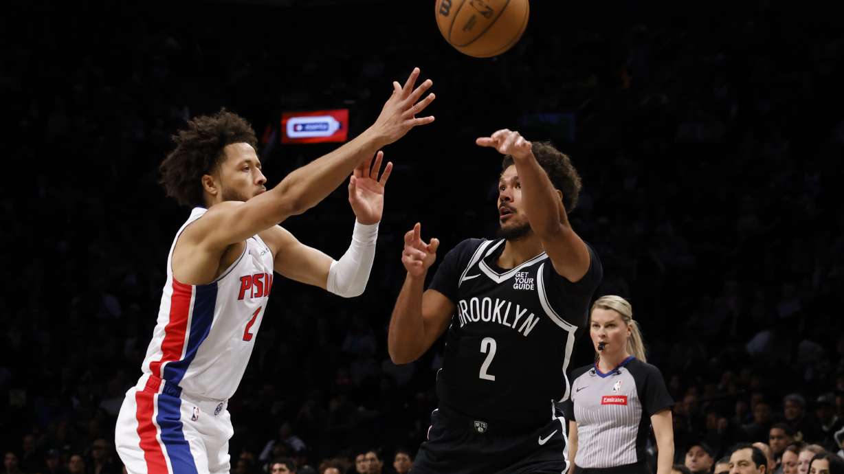 Brooklyn Nets' Cam Johnson, front right, passes the ball away from Detroit Pistons' Cade Cunningham, left, during the first quarter of an NBA basketball game Sunday, Nov. 3, 2024, in New York.
