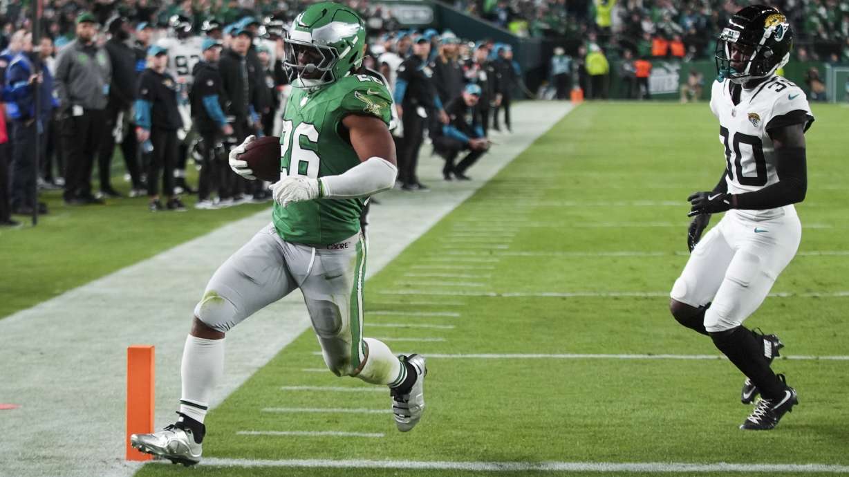 Philadelphia Eagles running back Saquon Barkley (26) scores a touchdown in front of Jacksonville Jaguars cornerback Montaric Brown (30) during the first half of an NFL football game Sunday, Nov. 3, 2024, in Philadelphia.