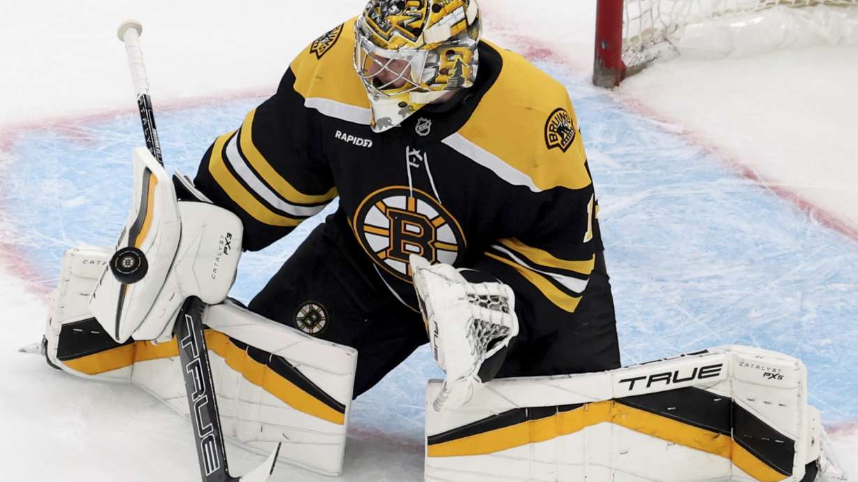 Boston Bruins goaltender Jeremy Swayman (1) deflects the puck during the second period of an NHL hockey game against Seattle Kraken, Sunday, Nov. 3, 2024, in Boston.