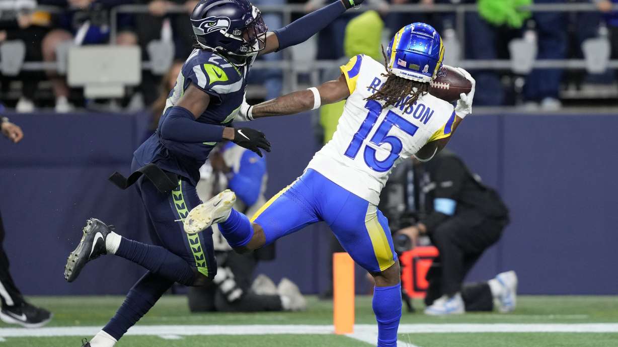 Los Angeles Rams wide receiver Demarcus Robinson (15) catches a touchdown pass against Seattle Seahawks cornerback Riq Woolen during overtime of an NFL football game in Seattle, Sunday, Nov. 3, 2024.