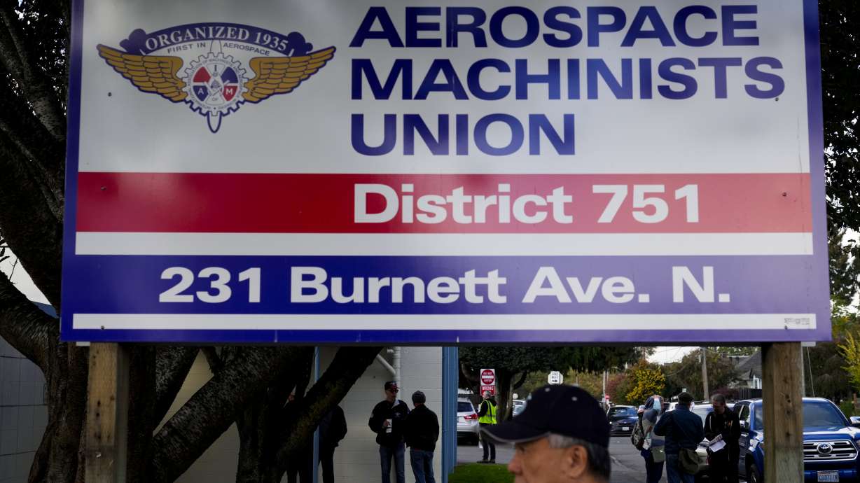 Boeing employees on strike arrive to vote on a new contract offer from the company Oct. 23, in Renton, Wash. Unionized factory workers at Boeing are voting Monday whether to accept a contract offer or to continue their strike.