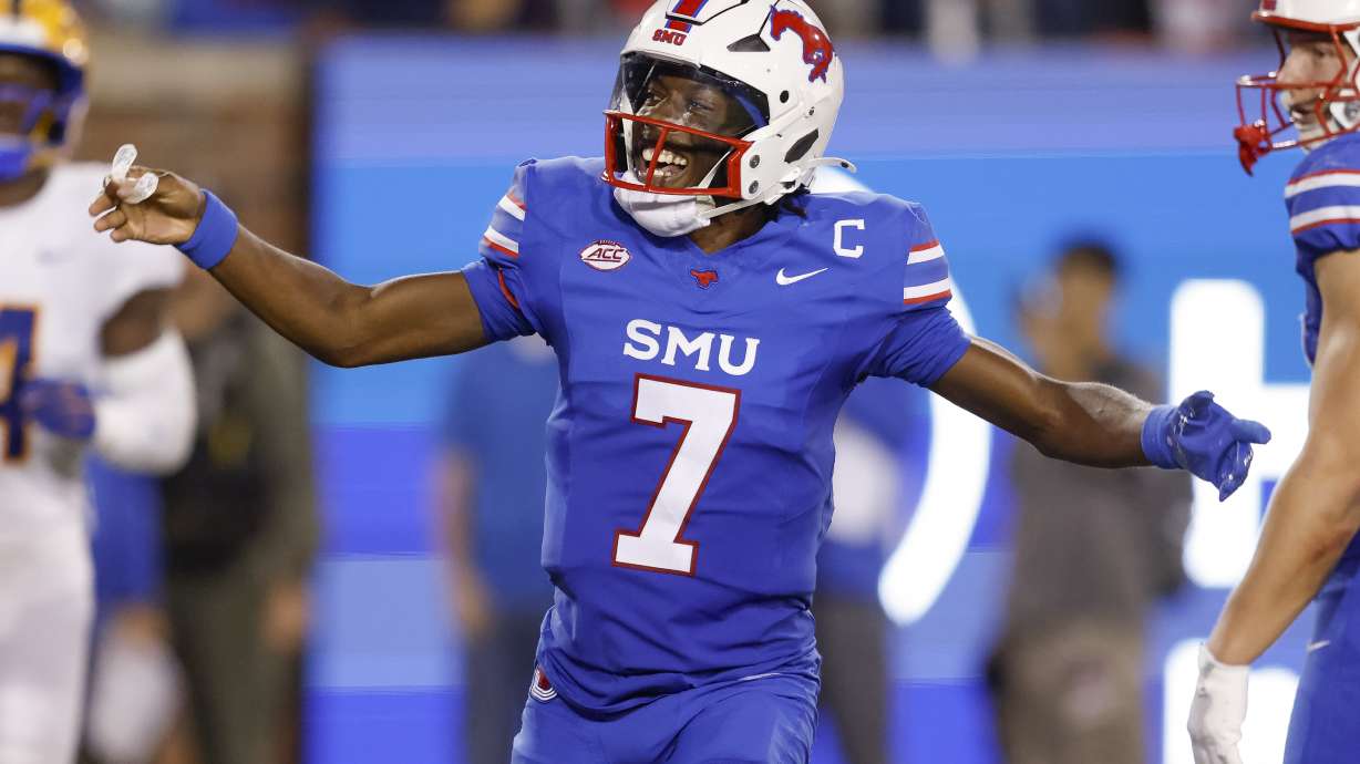 SMU quarterback Kevin Jennings (7) celebrates after throwing a touchdown pass during the first half of an NCAA college football game against Pittsburgh in Dallas, Saturday, Nov. 2, 2024.