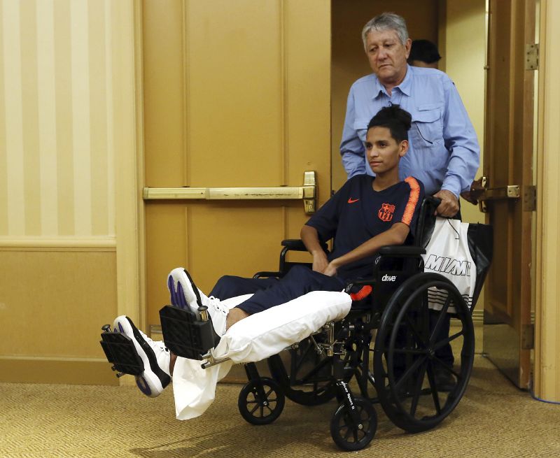 Anthony Borges is pushed by his grandfather Alfredo Borges at the start of a news conference in Plantation, Fla., April 6, 2018.