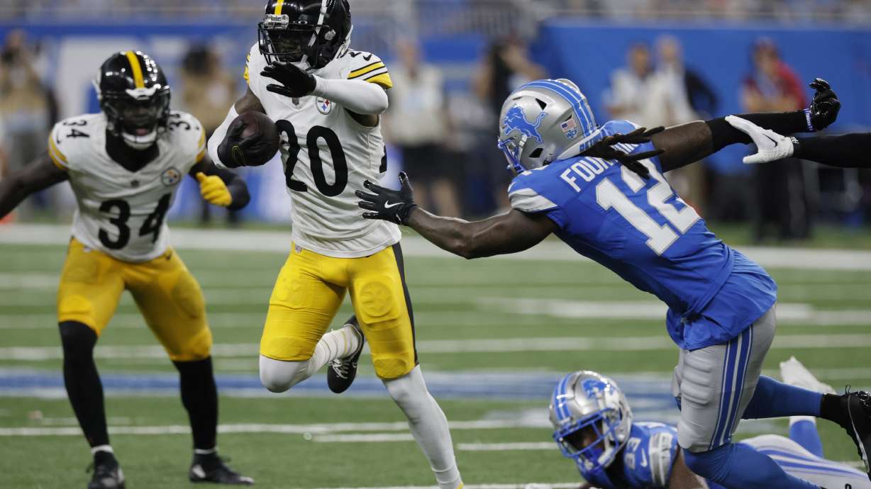 FILE - Pittsburgh Steelers cornerback Cameron Sutton (20) runs past Detroit Lions wide receiver Daurice Fountain (12) after an interception during the second half of an NFL preseason football game, Saturday, Aug. 24, 2024, in Detroit.